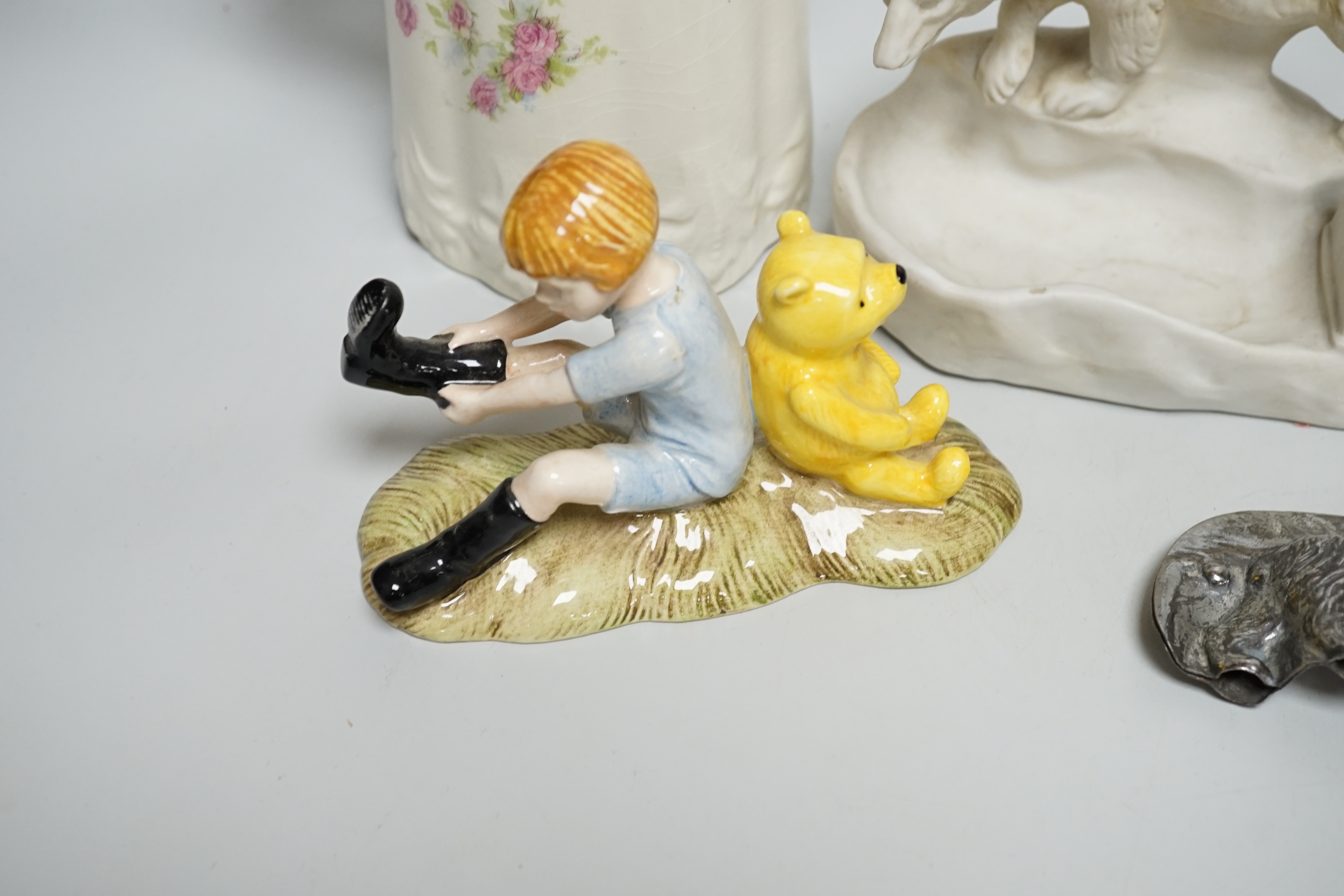 Four early teddy bear fairings, a Royal Doulton Christopher Robin and Pooh bear, a teddy bear chocolate mould and a jug with sporting teddy bears